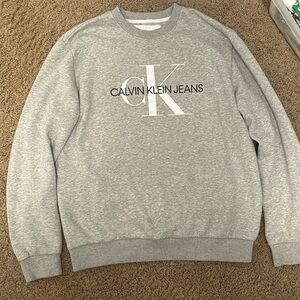 Calvin Klein sweater. colors are gray, white, and black.